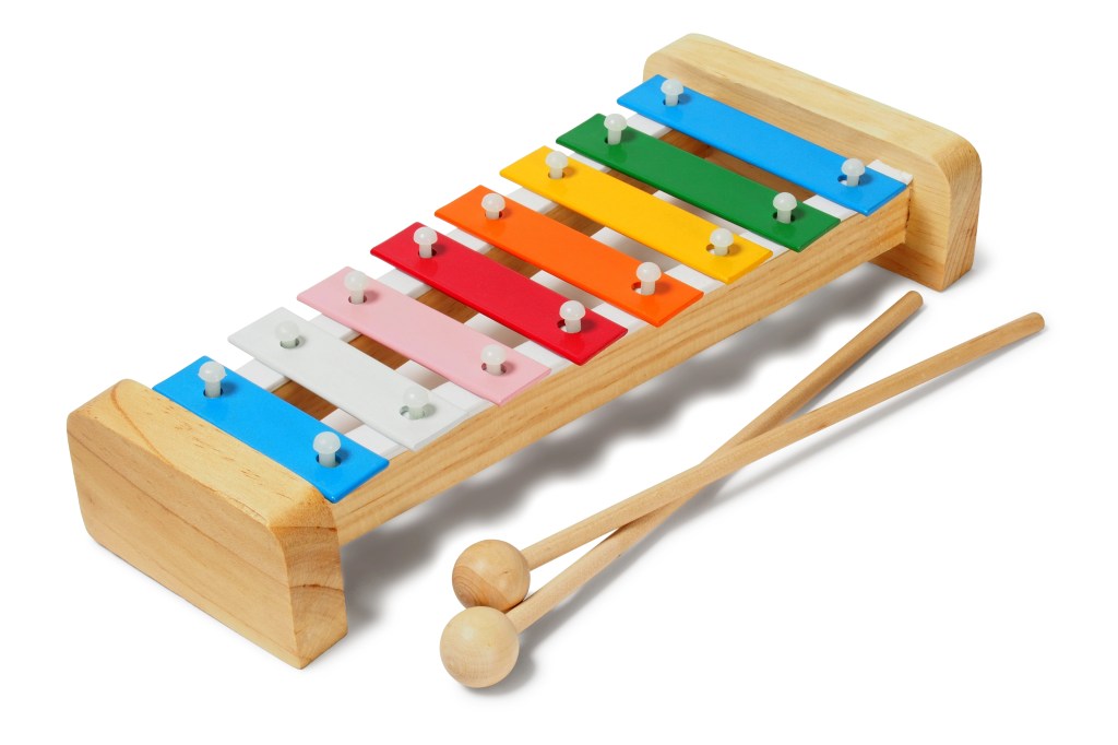 A colorful wooden xylophone with eight keys and two mallets.