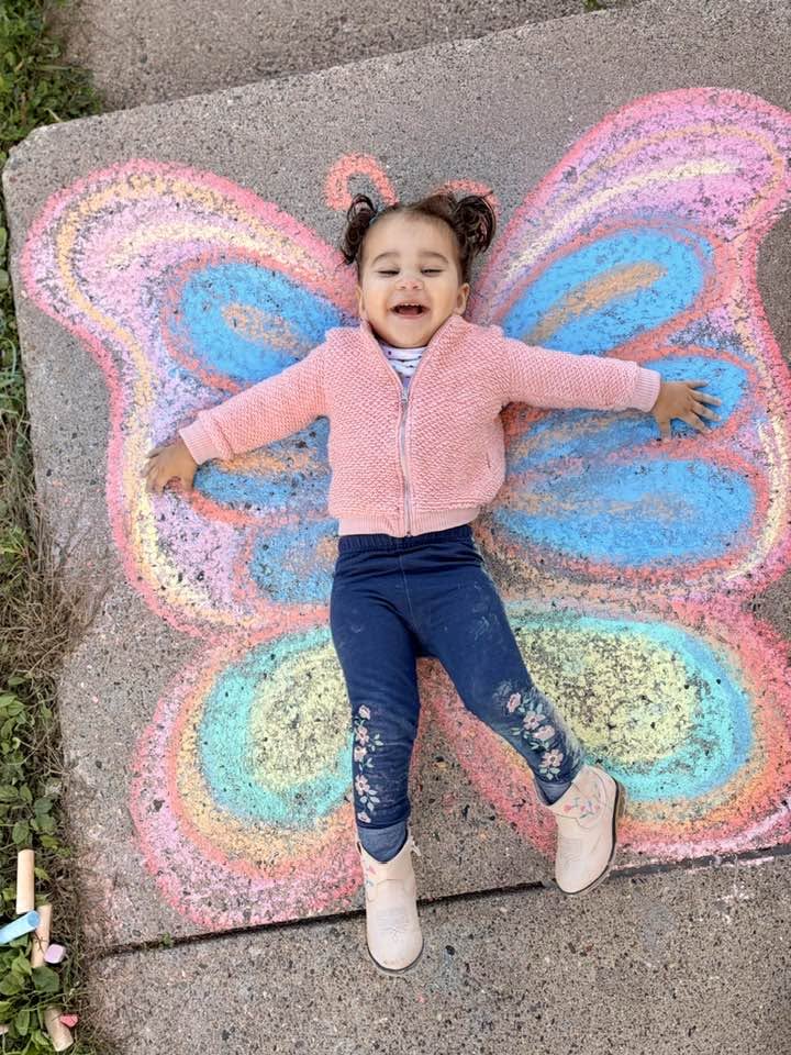 little girl laughing, butterfly